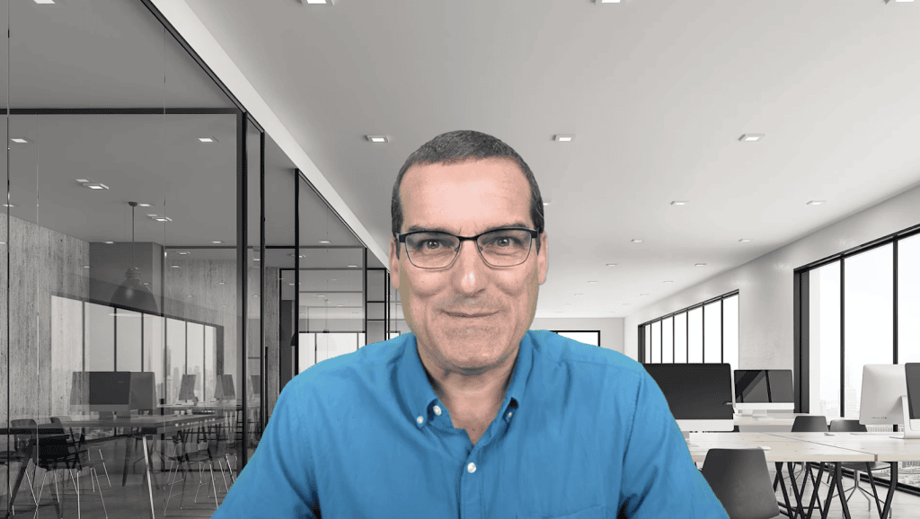 AIIT conference speaker in a professional modern office setting.