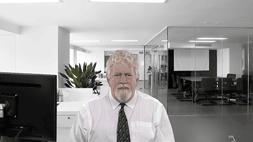 Professional man in office with modern workspace background.