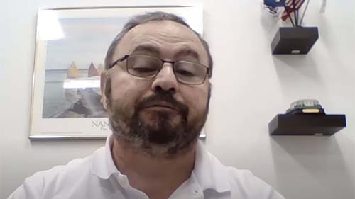 Man with glasses in an office setting, promoting AIIT.